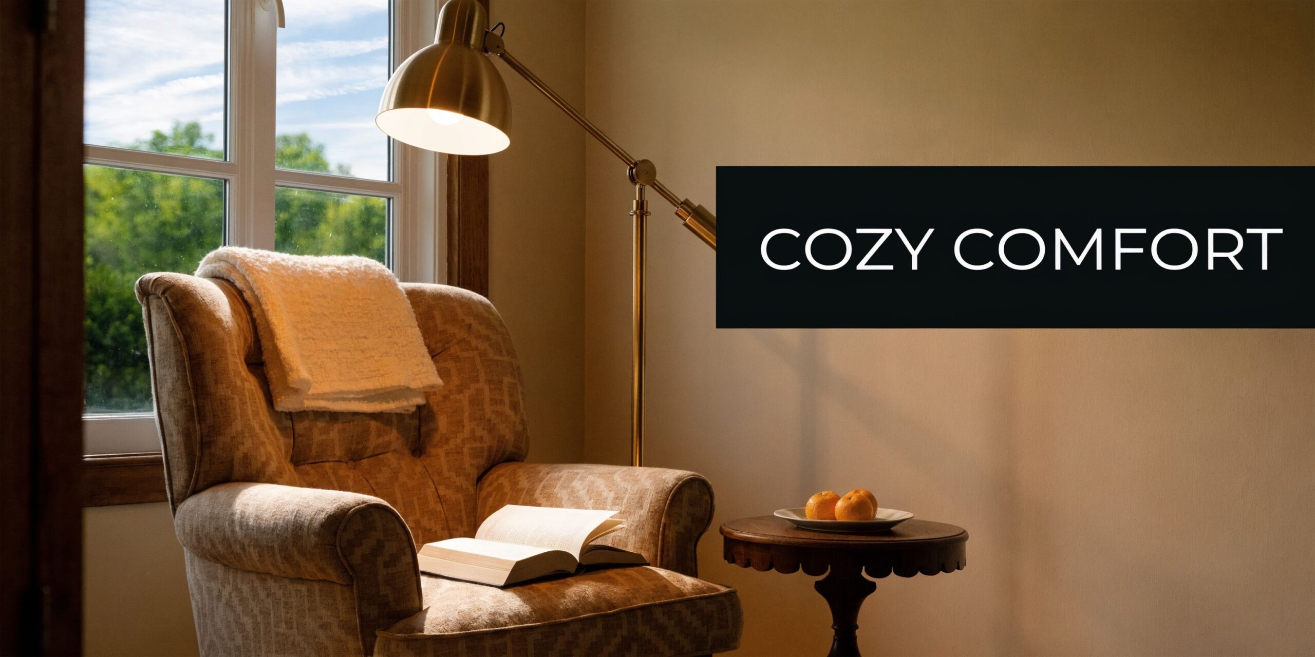 A cozy reading nook featuring an armchair with a blanket, an open book, and a brass lamp.