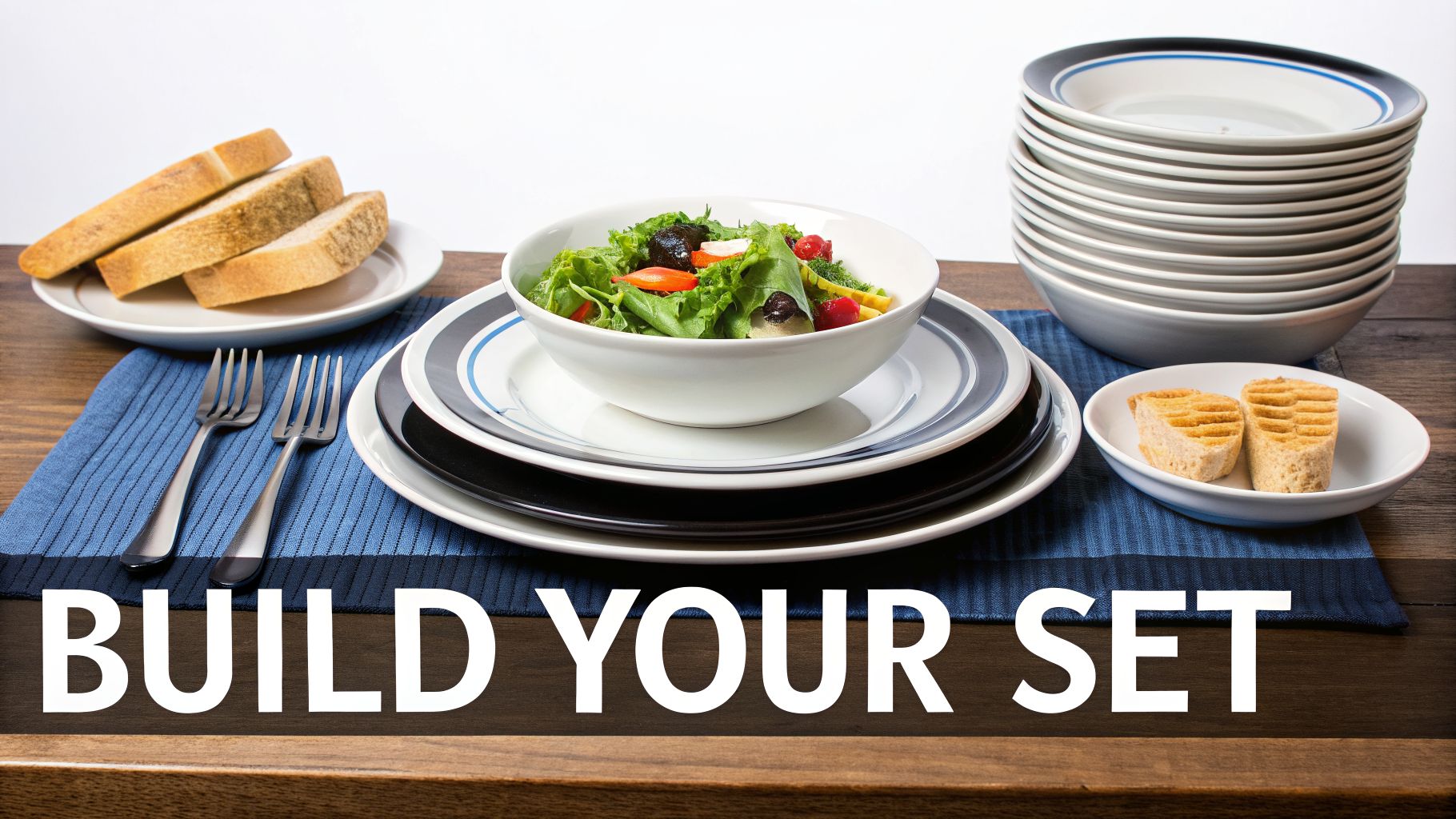 A dining table set with a variety of plates, bowls, forks, salad, bread, and dessert.